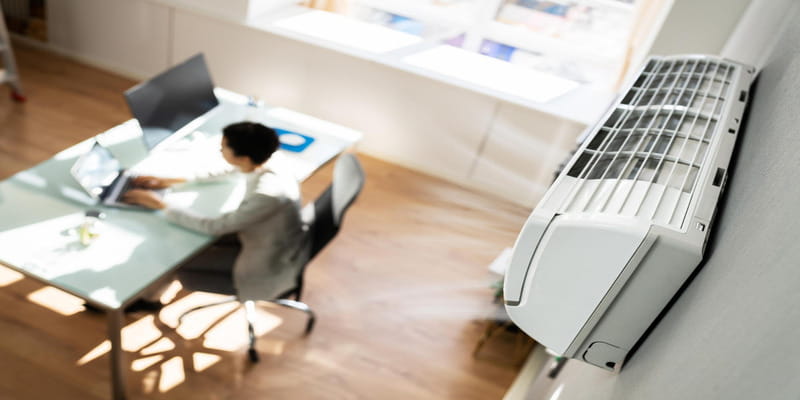 Wall-mounted AC cooling a school office space